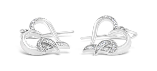Pair of white metal earrings with curved, intertwined design accented with small white gemstones in a pave setting, front angle.