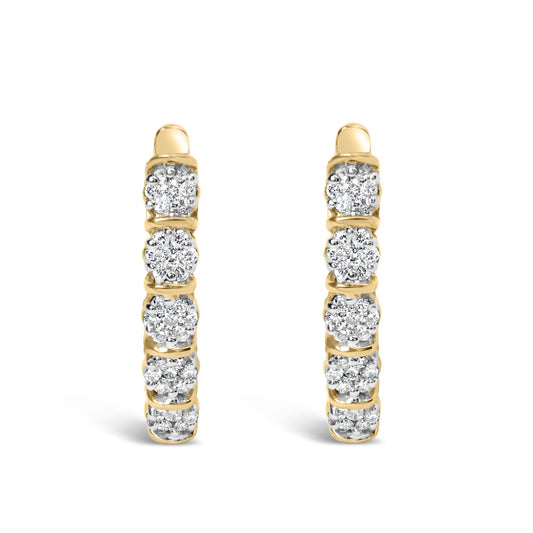 Front view of a pair of yellow metal hoop earrings featuring multiple round white gemstones in prong settings along the outer edge.