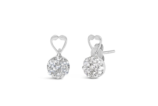 Pair of white metal earrings with round white gemstones in a cluster setting and an open heart detail at the top, shown from a front and angled side view.
