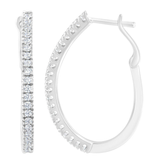 Close-up front and side view of white metal hoop earrings with round white gemstones in prong settings along the outer edge.
