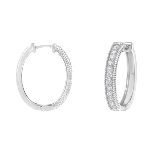 Pair of white metal hoop earrings with prong-set round white gemstones, shown from front and side angle on a white background.