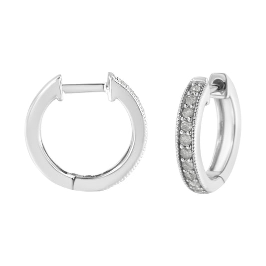 Pair of white metal hoop earrings with round white gemstones in prong setting along outer edge, shown from front and side angles on white background.