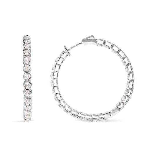 White metal hoop earrings with round white gemstones in prong settings, shown in front and side views on a white background.