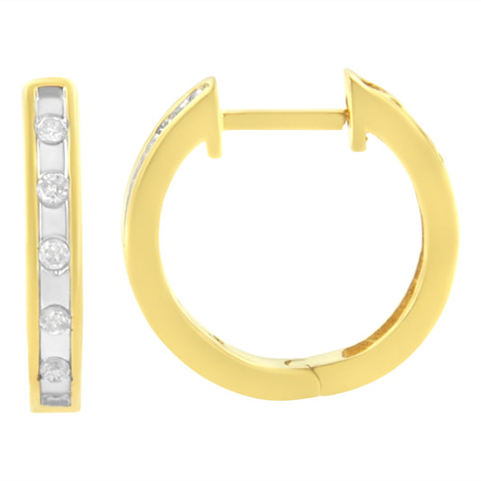 Close-up front and side views of yellow metal hoop earrings with round white gemstones set in channel along front.