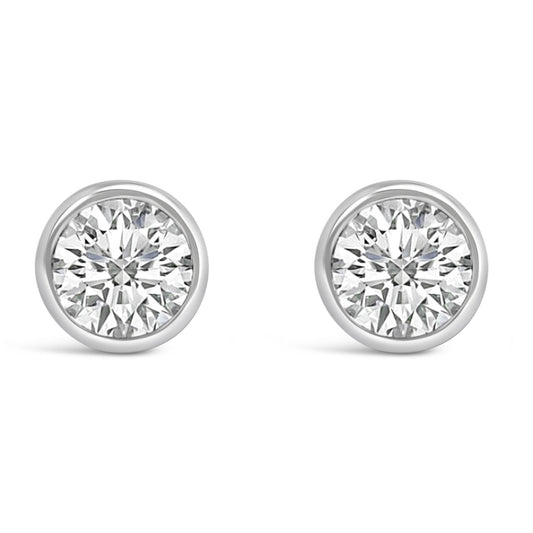Front view of a pair of white metal bezel-set round white gemstone stud earrings.