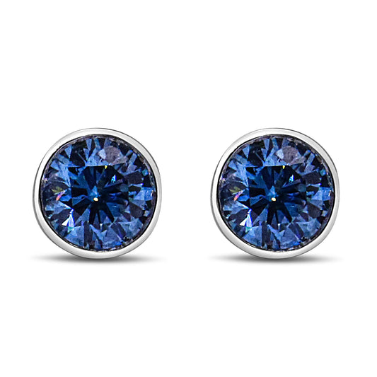 Front view of white metal stud earrings with round blue gemstones in bezel settings.