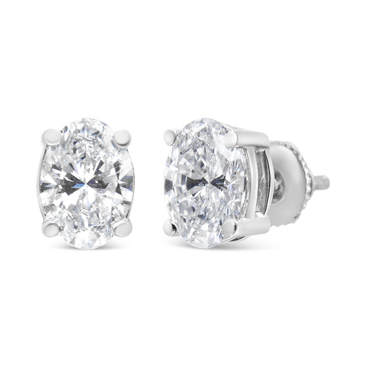 White metal stud earrings with oval-shaped white gemstones in four-prong settings, shown from front and side angles.