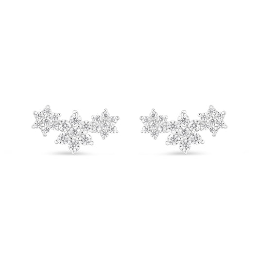 Close-up front view of a pair of white metal earrings featuring clusters of round white gemstones in prong settings arranged in a floral pattern, shown on a white background.