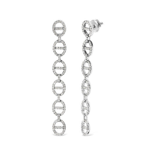 Close-up front and side view of long white earrings composed of linked oval shapes studded with round white gemstones in prong settings.
