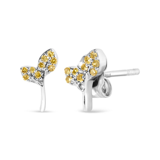 Close-up front angle of white metal earrings shaped like branches, adorned with multiple round yellow gemstones in prong settings.
