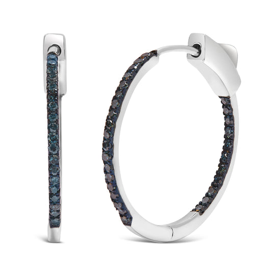 Close-up front and side views of white metal hoop earrings set with round blue gemstones in prong settings.