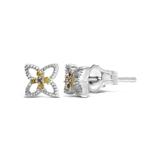 Pair of white metal stud earrings with a four-petal flower design featuring round yellow gemstones in prong settings, shown from front and side angles.