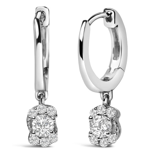 Close-up front view of a pair of white metal hoop earrings with dangling round white gemstones in prong settings arranged in a floral cluster.