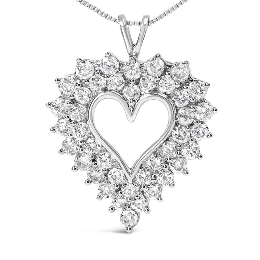 Front-facing view of a white metal heart-shaped necklace pendant adorned with round white gemstones in prong settings around the outline, with baguette white gemstones in channel settings forming the inner design.