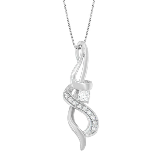 Close-up front view of a white metal necklace pendant with an abstract, flowing design featuring one round prong-set white gemstone and a row of smaller white gemstones along a curved section.