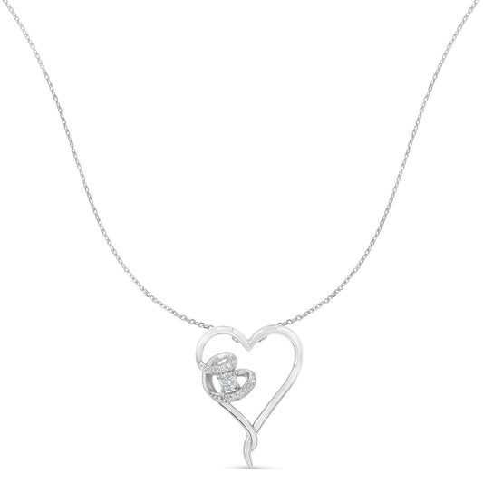 Front view of a white metal heart-shaped necklace pendant with a cluster of round white gemstones in prong settings on one side, suspended on a delicate chain.