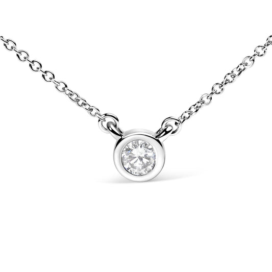 Close-up front angle of a white metal necklace with a round white gemstone in a bezel setting.