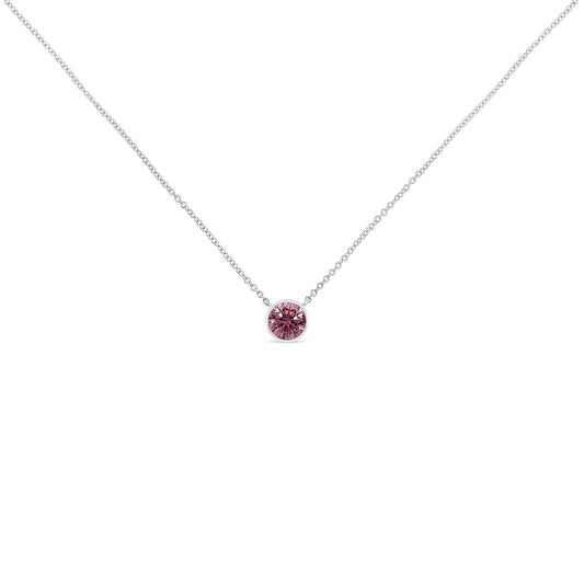 Front view of a white necklace with a single round pink gemstone set in bezel on a fine chain.