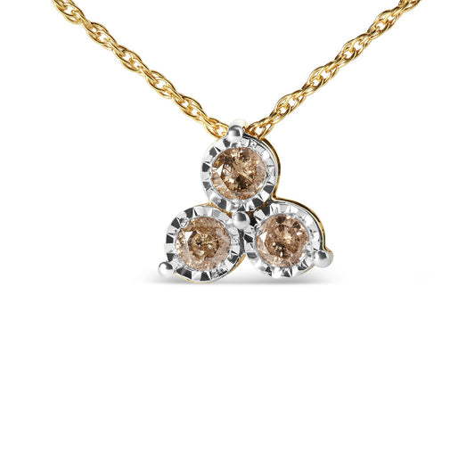 Front-angle view of a yellow and white metal necklace with a pendant featuring three round prong-set brown gemstones surrounded by a white metal border.