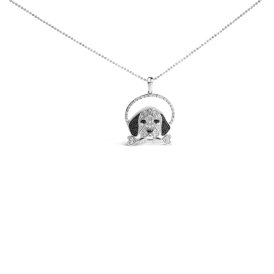 Front-facing shot of a white metal necklace pendant shaped like a dog’s face with ears and a bone in its mouth, decorated with white and black micro-pave and prong-set round gemstones, suspended from a delicate chain.