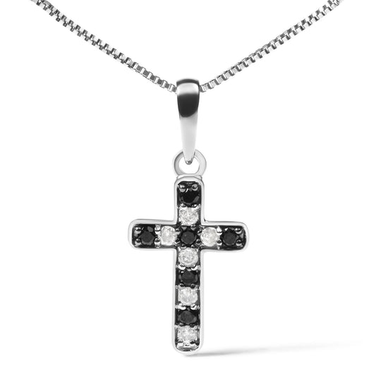 Front view of a white metal cross-shaped necklace pendant with alternating black and white round gemstones in prong settings, hanging from a white metal chain.