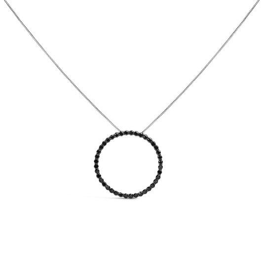 Front view of white necklace with circular pendant set with round black gemstones in shared prong setting on a white background.