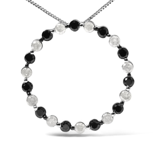 Front-facing shot of a white metal necklace with alternating round black and white gemstones in prong settings forming a circle.
