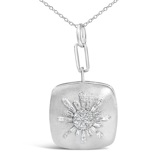 Close-up front view of a white metal necklace pendant with a sunburst design featuring baguette and round white gemstones.