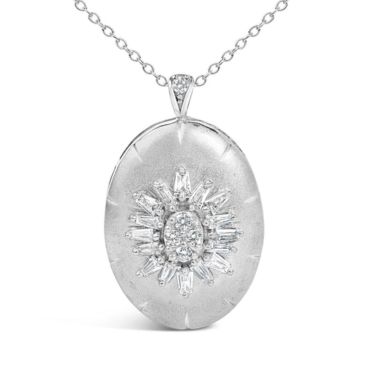 Close-up front view of a white metal necklace with an oval pendant featuring a starburst design composed of round and baguette-shaped white gemstones with prong settings. The necklace is shown on a white background.