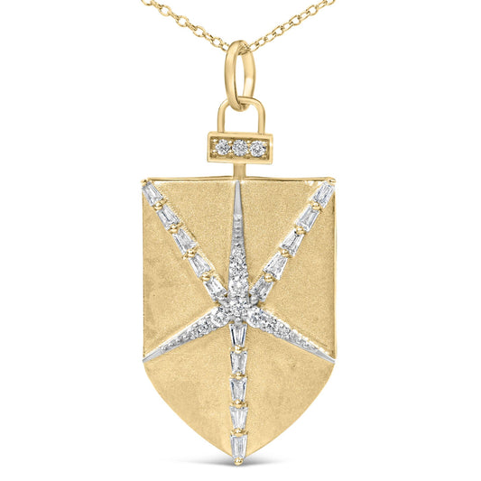 Close-up front view of a yellow metal shield-shaped necklace pendant featuring a starburst pattern of white round and baguette-shaped gemstones in prong settings, shown on a white background.