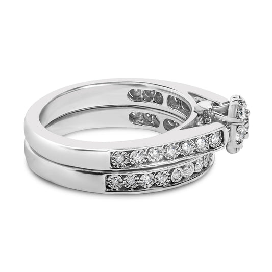 White metal ring set shown in a close-up side view, featuring two bands with round white gemstones in prong settings along the outer surfaces.