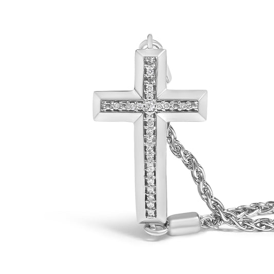 Close-up front angle of a white metal cross-shaped bracelet pendant with a vertical and horizontal line of white round pave-set gemstones, shown with part of a twisted chain.