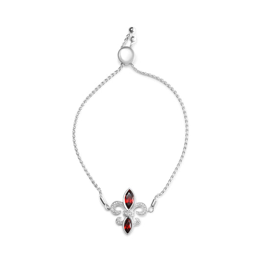 Bracelet with a white metal braided chain and a fleur-de-lis shaped centerpiece featuring two red marquise-shaped gemstones and multiple small round white gemstones, shown from a top-down angle on a white background.