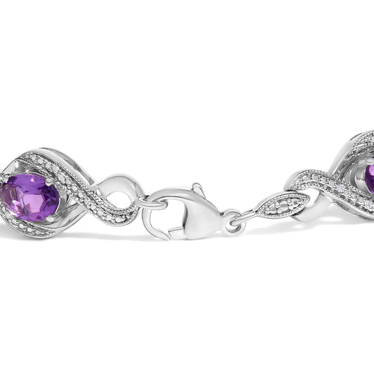 Close-up image of a white bracelet with oval purple gemstones and round white gemstones in prong settings, shown flat with the clasp visible, photographed from the top angle.