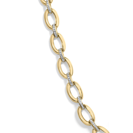 Close-up angled view of a yellow metal necklace featuring oval links connected by smaller links paved with white round gemstones.