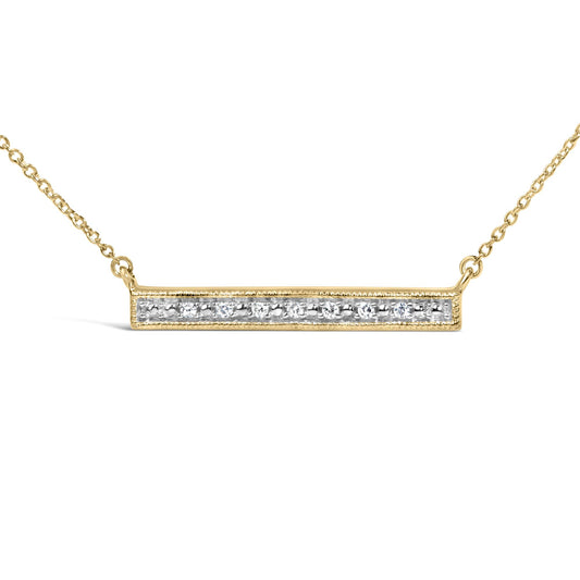 Close-up front angle of a yellow metal necklace with a horizontal rectangular bar pendant set with round white gemstones in prong settings.