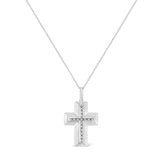 Front-facing shot of a white metal cross necklace with a smaller cross of white round prong-set gemstones in the center, hanging from a delicate white chain.
