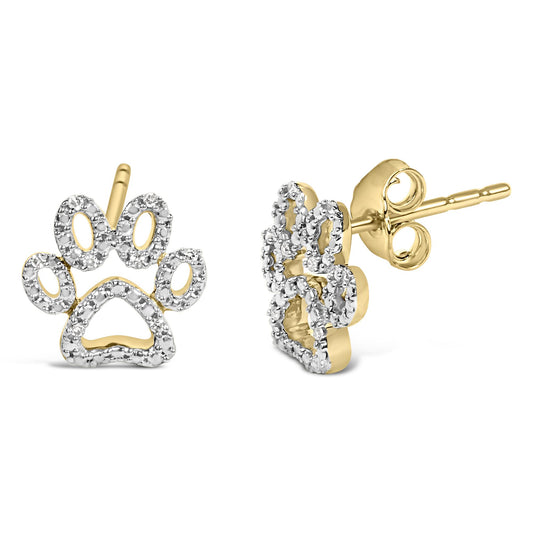 Close-up side angle of yellow metal earrings shaped like a paw print, adorned with small white gemstones in prong settings.