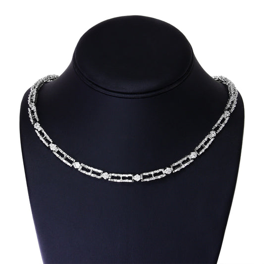 Front view of a white necklace on a black display stand featuring baguette-shaped white gemstones in prong settings linked with round white gemstones in channel settings.