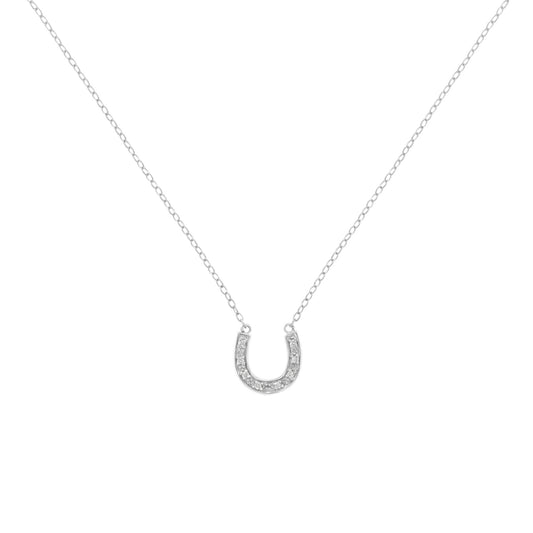 Front-facing shot of a white metal necklace with a horseshoe-shaped pendant set with small round white gemstones in a pave setting.