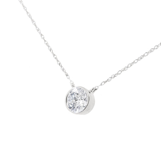Close-up front angle of a white metal necklace with a single round white gemstone in a bezel setting.