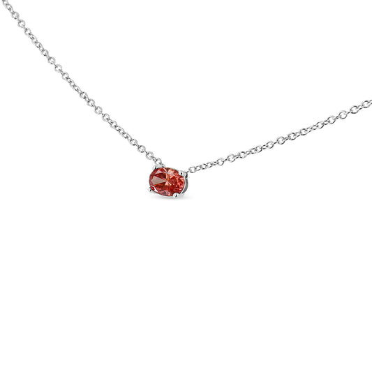 Close-up front angle of a white metal necklace with a single oval-shaped pink gemstone in a four-prong setting.