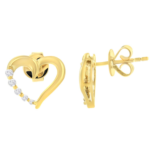 Front and side views of yellow metal heart-shaped stud earrings with a row of small white gemstones on one side, shown on a white background.