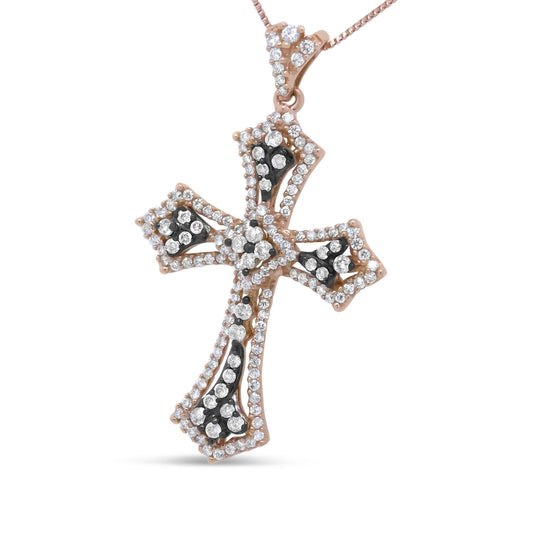 Close-up front angle of a rose metal cross-shaped necklace pendant adorned with round white and brown prong-set gemstones.