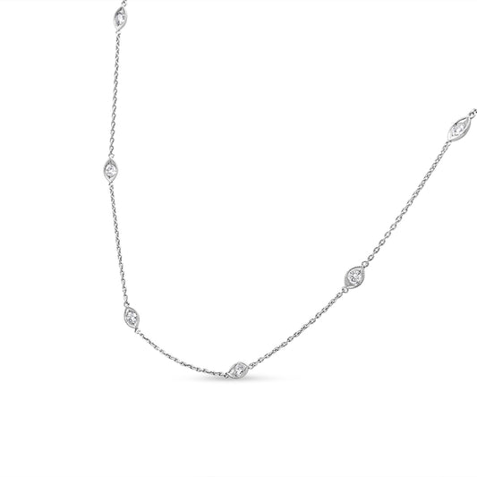 White metal necklace with round bezel-set white gemstones spaced along the chain, shown against a white background at a slight angle.