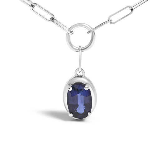 Close-up front angle of a white metal necklace with an oval-shaped blue gemstone pendant in prong setting hanging from a circular link.