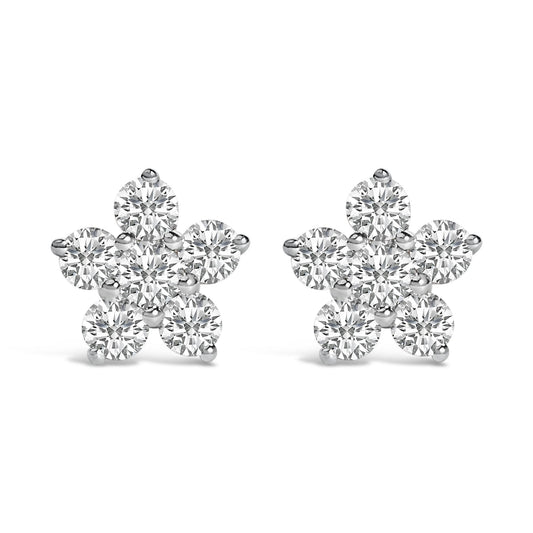 Pair of white metal flower-shaped earrings with round white gemstones in prong settings, shown from the front on a white background.