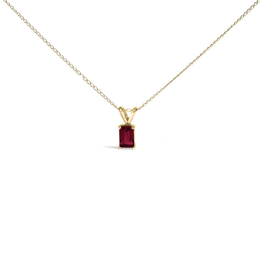 Yellow necklace with an emerald-shaped red gemstone pendant in a four-prong setting, shown from the front on a white background.