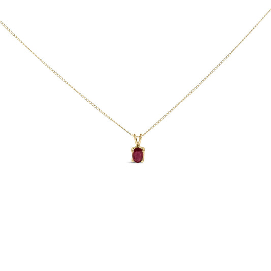 Front view of yellow metal necklace with oval red gemstone in a four-prong setting.