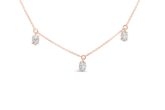 Close-up front view of a rose-colored necklace with three oval-shaped white gemstones in 4-prong settings evenly spaced along the chain.